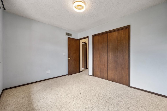 1131 Penkridge Dr, Iowa City, IA 52246 - unfurnished bedroom with carpet, a closet, and a textured ceiling