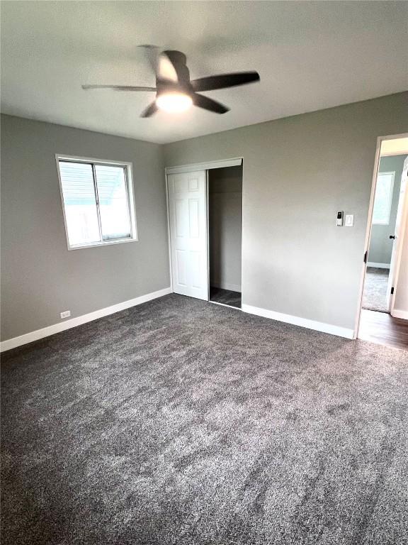 1705 NE Texas Ave, Cedar Rapids, IA 52402 - unfurnished bedroom with carpet, a closet, and a ceiling fan