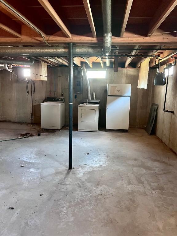 1705 NE Texas Ave, Cedar Rapids, IA 52402 - basement with washer / clothes dryer, freestanding refrigerator, and healthy amount of natural light