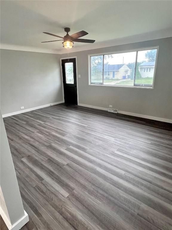 1705 NE Texas Ave, Cedar Rapids, IA 52402 - unfurnished room featuring ceiling fan and dark wood-style floors
