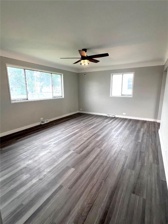 1705 NE Texas Ave, Cedar Rapids, IA 52402 - empty room featuring dark wood-style flooring and ceiling fan