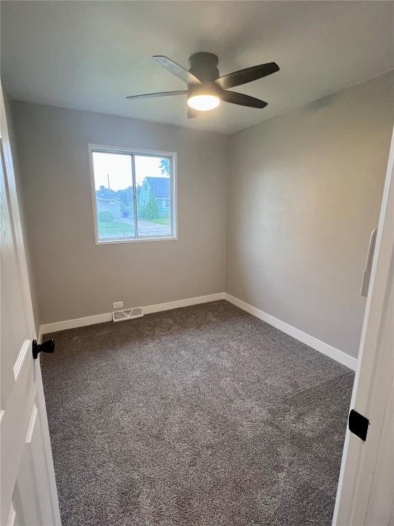 1705 NE Texas Ave, Cedar Rapids, IA 52402 - carpeted spare room featuring ceiling fan and baseboards