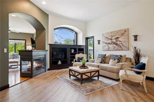 5512 Black Oak Dr NE, Cedar Rapids, IA 52411 - living room featuring healthy amount of natural light, wood finished floors, a multi sided fireplace, recessed lighting, and a ceiling fan