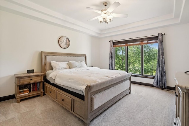 5512 Black Oak Dr NE, Cedar Rapids, IA 52411 - bedroom with light colored carpet, a tray ceiling, and ceiling fan