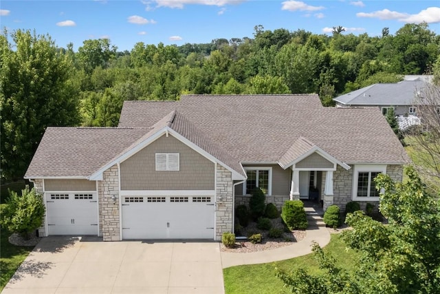 5512 Black Oak Dr NE, Cedar Rapids, IA 52411 - craftsman-style home with stone siding, a garage, driveway, and roof with shingles