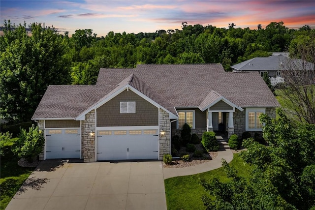 5512 Black Oak Dr NE, Cedar Rapids, IA 52411 - craftsman-style house featuring an attached garage, stone siding, concrete driveway, and roof with shingles