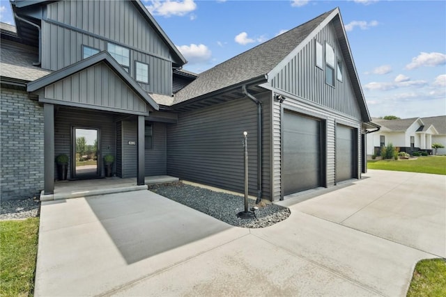 4395 Rec Dr, Marion, IA 52302 - view of front of property featuring board and batten siding, roof with shingles, a garage, and concrete driveway