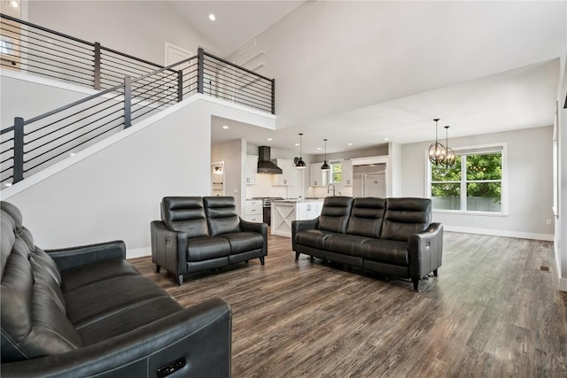 4395 Rec Dr, Marion, IA 52302 - living room featuring a chandelier, dark wood-style floors, stairs, a high ceiling, and recessed lighting