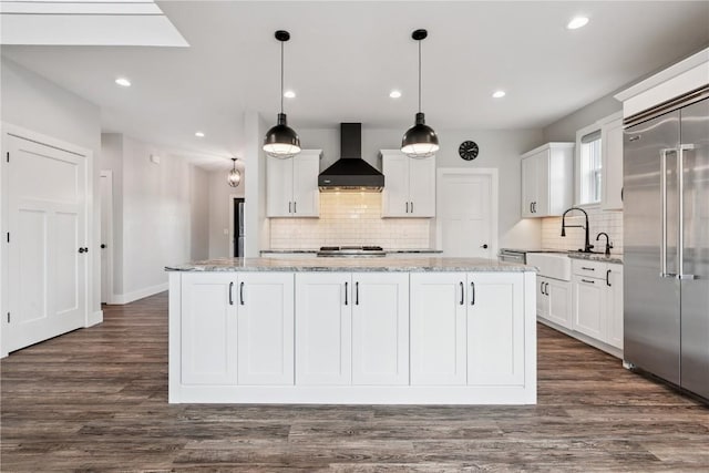 4395 Rec Dr, Marion, IA 52302 - kitchen featuring wall chimney range hood, stainless steel built in fridge, backsplash, white cabinets, and recessed lighting