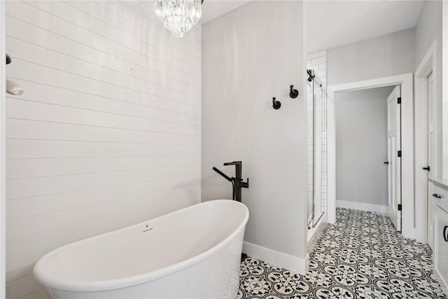 4395 Rec Dr, Marion, IA 52302 - bathroom featuring a stall shower, a soaking tub, and a chandelier