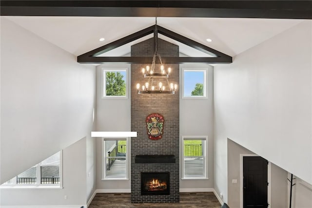 4395 Rec Dr, Marion, IA 52302 - living room with a chandelier, dark wood-type flooring, high vaulted ceiling, a fireplace, and plenty of natural light