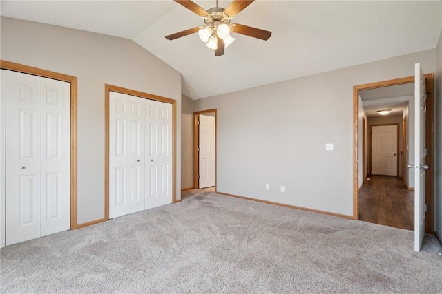 247 Kelso Ln, Fairfax, IA 5228 - unfurnished bedroom featuring carpet flooring, vaulted ceiling, two closets, and a ceiling fan
