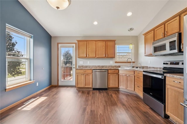 247 Kelso Ln, Fairfax, IA 5228 - kitchen with stainless steel appliances, vaulted ceiling, plenty of natural light, dark wood finished floors, and recessed lighting