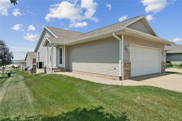 247 Kelso Ln, Fairfax, IA 5228 - view of side of property featuring an attached garage, a yard, roof with shingles, concrete driveway, and brick siding
