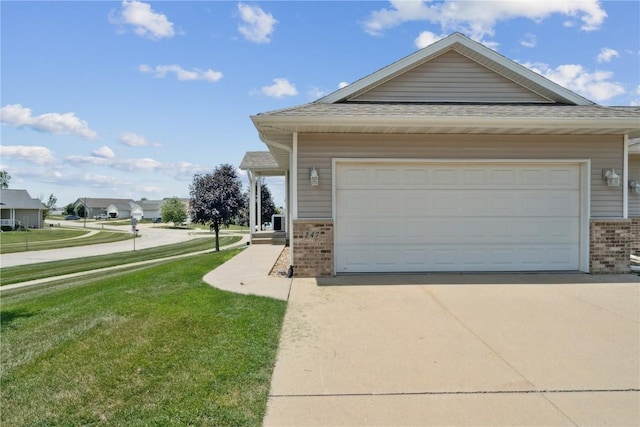 247 Kelso Ln, Fairfax, IA 5228 - view of front of house with brick siding, driveway, a front yard, and roof with shingles