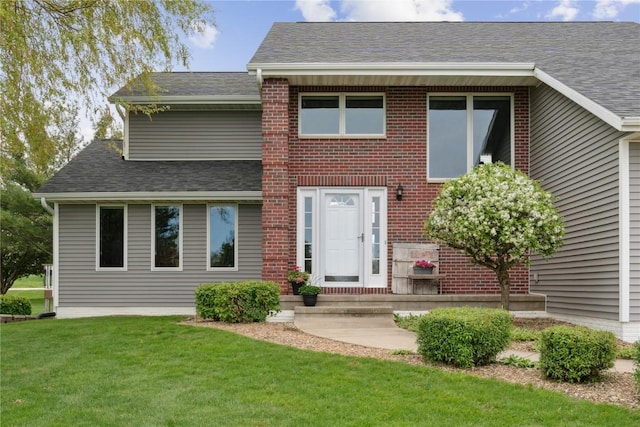 4199 Brookside Dr, Marion, IA 52302 - view of front of house featuring a front yard, brick siding, and roof with shingles