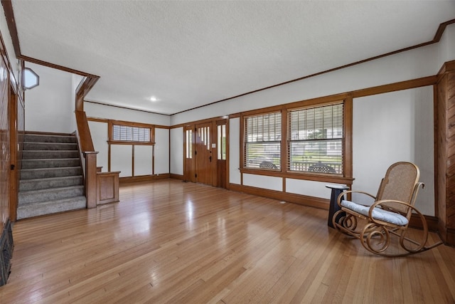 308 Main St, Norway, IA 52318 - entrance foyer featuring light wood-style flooring, plenty of natural light, stairway, and a textured ceiling