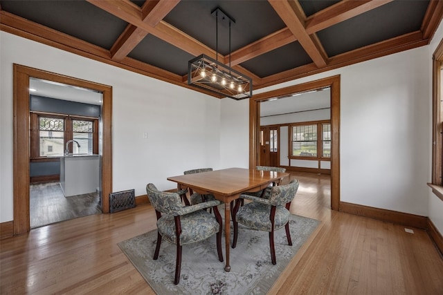 308 Main St, Norway, IA 52318 - dining space with healthy amount of natural light, coffered ceiling, light wood finished floors, and beam ceiling