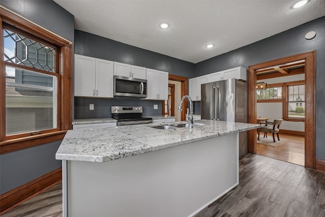 308 Main St, Norway, IA 52318 - kitchen featuring appliances with stainless steel finishes, dark wood-style flooring, white cabinetry, and recessed lighting