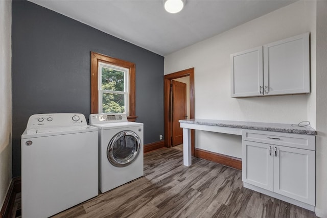 308 Main St, Norway, IA 52318 - laundry area featuring washer and dryer, light wood finished floors, and cabinet space