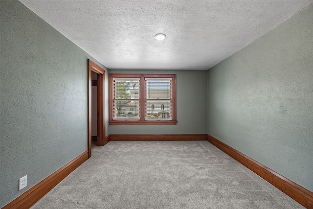 308 Main St, Norway, IA 52318 - spare room with a textured wall, carpet flooring, and a textured ceiling