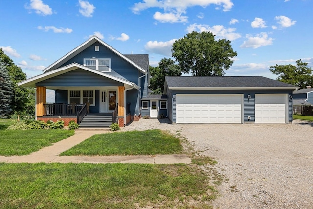 308 Main St, Norway, IA 52318 - view of front of home featuring gravel driveway, a front lawn, a porch, and an attached garage