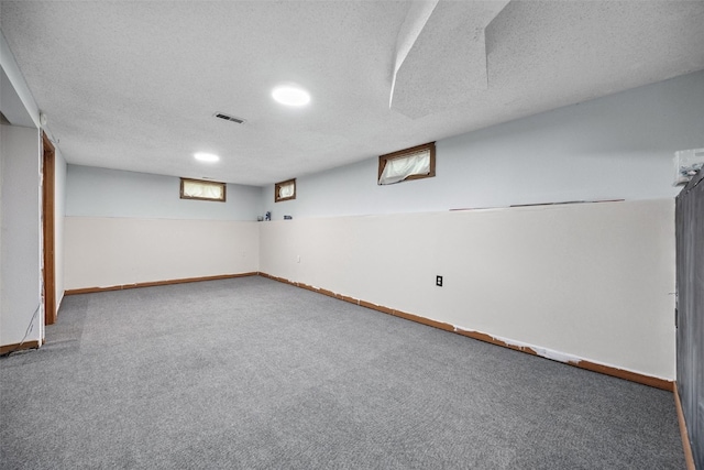 107 Spruce St, Blairstown, IA 52209 - below grade area with carpet floors and a textured ceiling