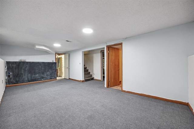 107 Spruce St, Blairstown, IA 52209 - finished below grade area with carpet, stairway, a textured ceiling, and recessed lighting