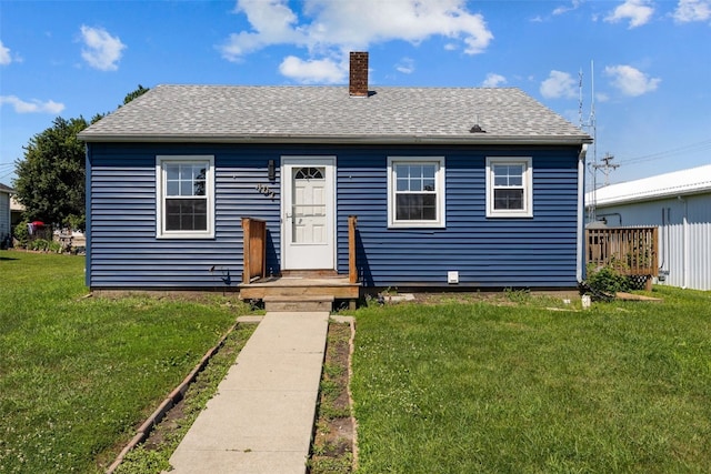 107 Spruce St, Blairstown, IA 52209 - bungalow-style house with a chimney, a front lawn, and roof with shingles