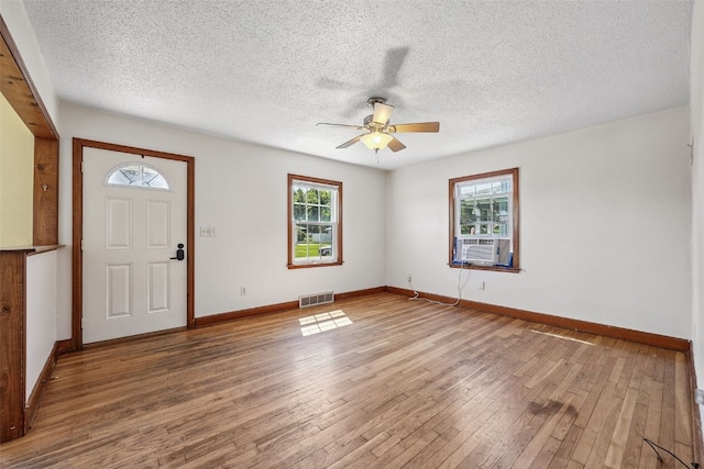 107 Spruce St, Blairstown, IA 52209 - entrance foyer with hardwood / wood-style floors, a ceiling fan, and a textured ceiling