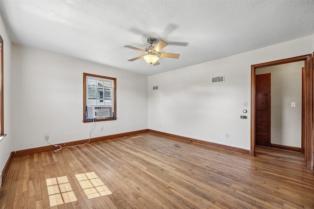 107 Spruce St, Blairstown, IA 52209 - unfurnished room with light wood finished floors, ceiling fan, a textured ceiling, and cooling unit
