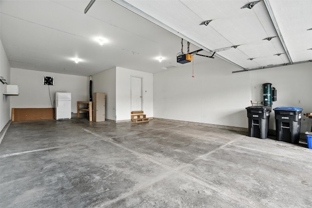 965 Hampshire Dr, Marion, IA 52328 - garage featuring a garage door opener and freestanding refrigerator