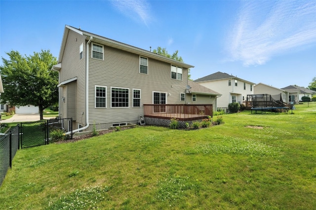 965 Hampshire Dr, Marion, IA 52328 - back of house featuring a trampoline, a deck, and a gate