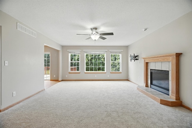 965 Hampshire Dr, Marion, IA 52328 - unfurnished living room featuring light colored carpet, a ceiling fan, and a tile fireplace