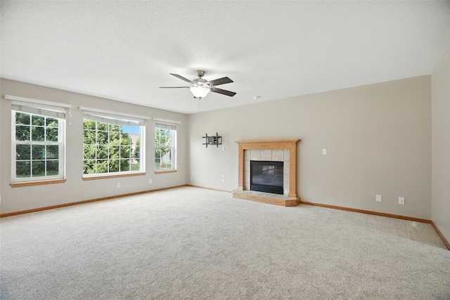 965 Hampshire Dr, Marion, IA 52328 - unfurnished living room with carpet floors, ceiling fan, and a tile fireplace