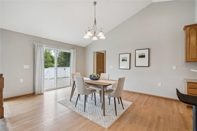 405 Linn Dr, Palo, IA 52324 - dining area featuring a chandelier, light wood finished floors, and high vaulted ceiling