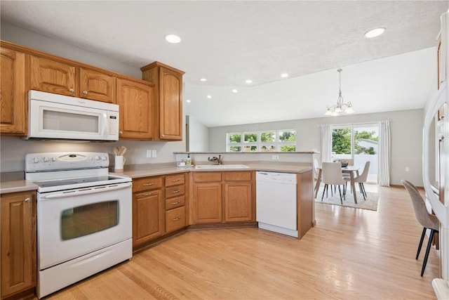 405 Linn Dr, Palo, IA 52324 - kitchen with white appliances, a chandelier, a peninsula, light wood finished floors, and light countertops