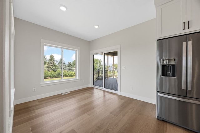 4018 Peridot Dr, Marion, IA 52302 - kitchen featuring stainless steel fridge, light wood-style flooring, white cabinetry, and recessed lighting