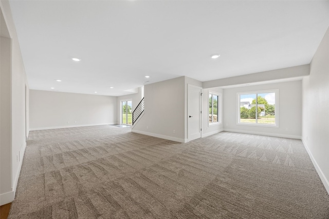 4018 Peridot Dr, Marion, IA 52302 - unfurnished living room featuring light colored carpet, stairs, and recessed lighting