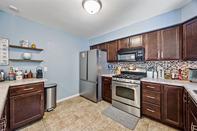 1608 10th St, Coralville, IA 52241 - kitchen with appliances with stainless steel finishes, backsplash, and light countertops
