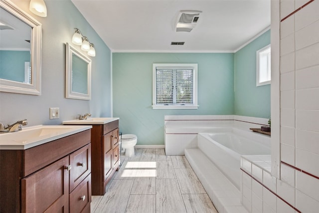 1608 10th St, Coralville, IA 52241 - bathroom with two vanities, a bath, and crown molding