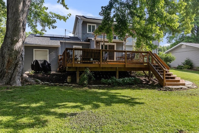 1608 10th St, Coralville, IA 52241 - back of house with roof mounted solar panels, a yard, a wooden deck, and stairs