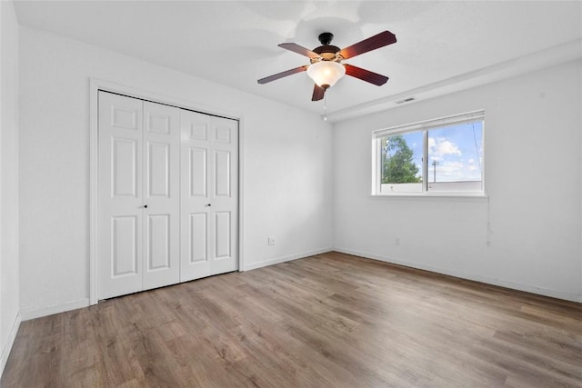 3107 Johnson Ave NW Unit 4, Cedar Rapids, IA 52405 - unfurnished bedroom featuring wood finished floors, a closet, and ceiling fan