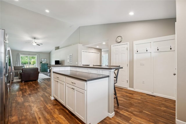 3016 Sherwood Dr, Marion, IA 52302 - kitchen with dark countertops, a kitchen bar, dark wood-style floors, a ceiling fan, and stainless steel refrigerator