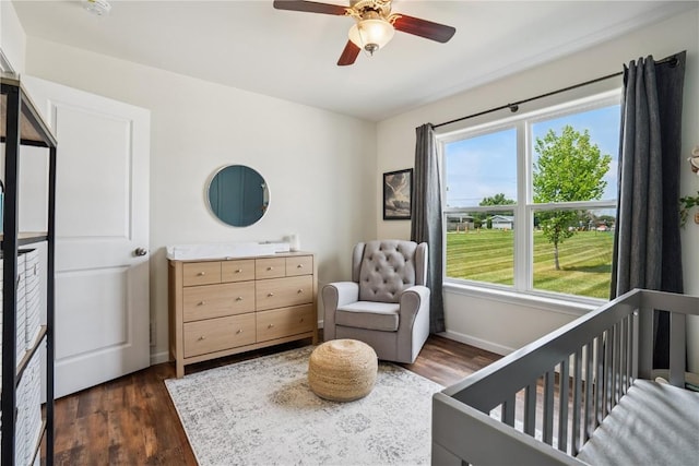 3016 Sherwood Dr, Marion, IA 52302 - bedroom featuring multiple windows, dark wood-style flooring, and a crib