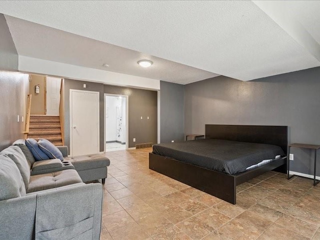 2007 S Ridge Dr, Coralville, IA 52241 - bedroom with a textured ceiling and connected bathroom