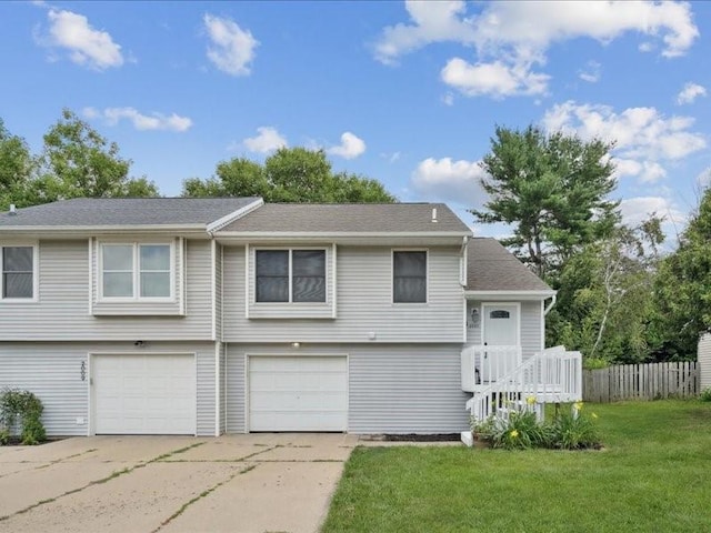 2007 S Ridge Dr, Coralville, IA 52241 - view of front facade with driveway, an attached garage, and roof with shingles