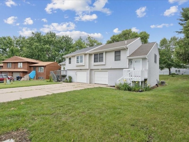 2007 S Ridge Dr, Coralville, IA 52241 - view of front of house with concrete driveway, an attached garage, and a front lawn