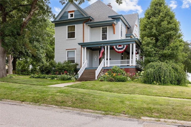 103 10th Ave SW, Mount Vernon, IA 52314 - victorian-style house featuring covered porch, a front lawn, and roof with shingles