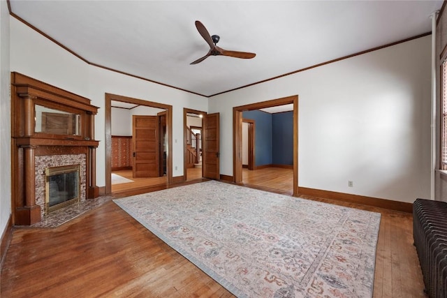 103 10th Ave SW, Mount Vernon, IA 52314 - living area featuring wood finished floors, a ceiling fan, crown molding, and a premium fireplace